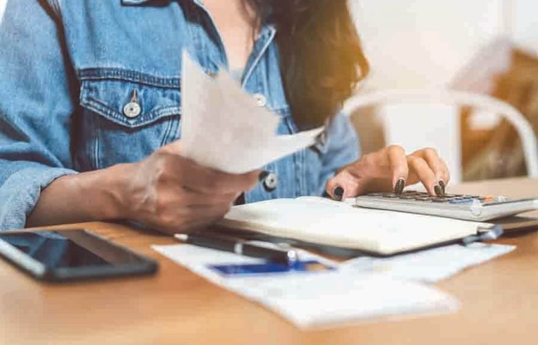 women calculating her finances to purchase a new car