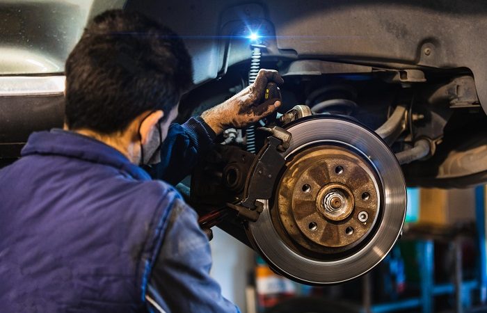 mechanic changing car brakes