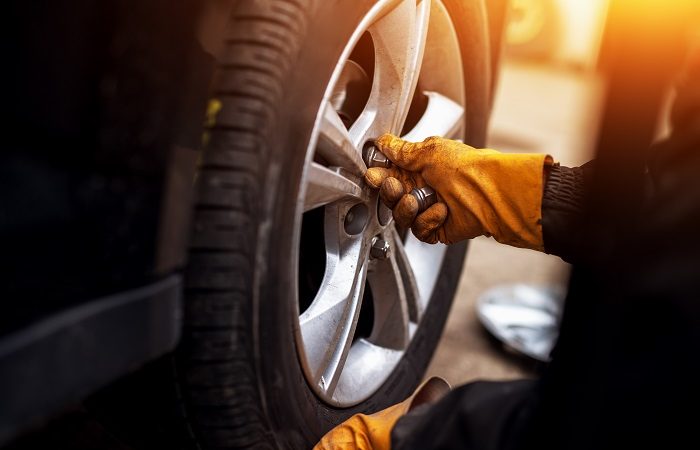 mechanic changing car tyres and rims