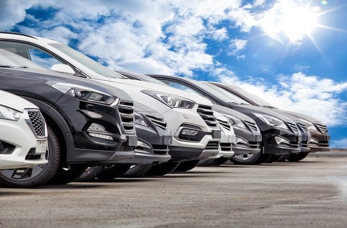 a row of parallel imported cars a row of parallel imported cars