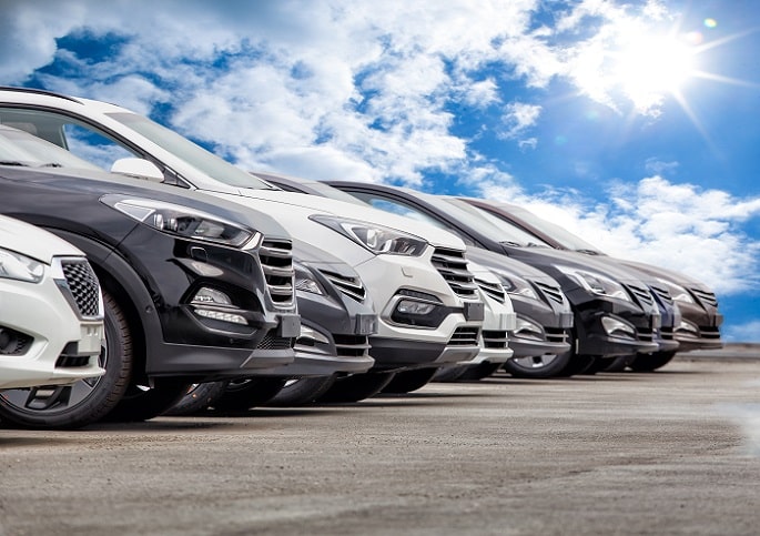 a row of parallel imported cars