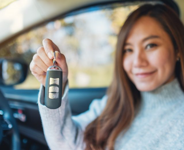 asian woman in her first car