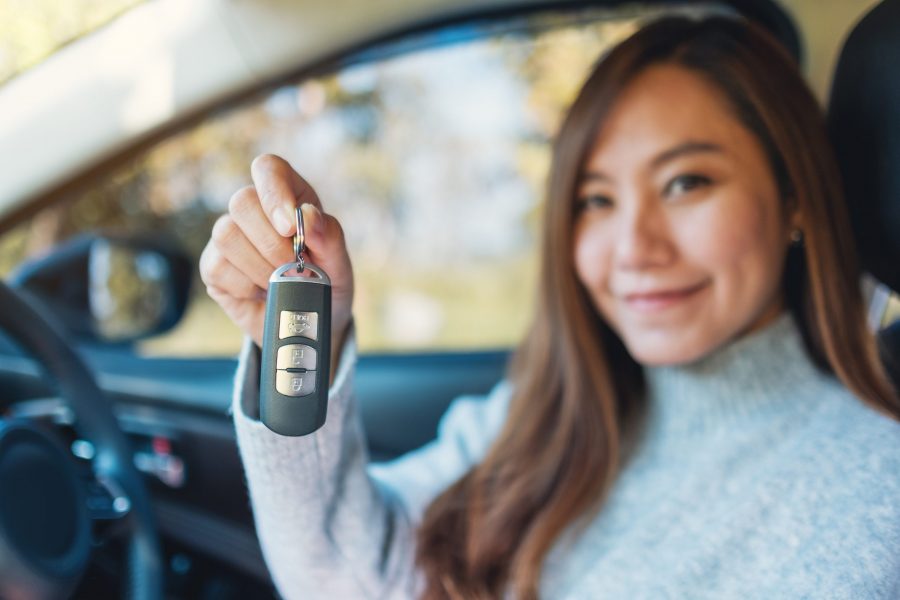 asian woman in her first car