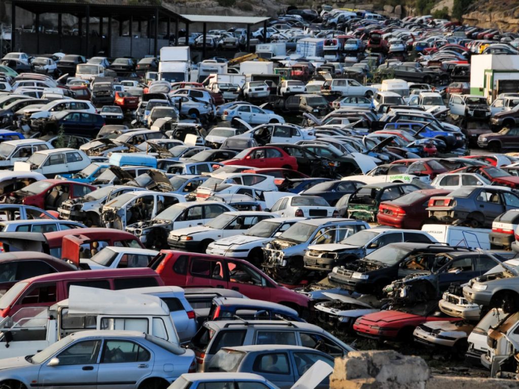 Piles of old vehicles at scrap car singapore yard