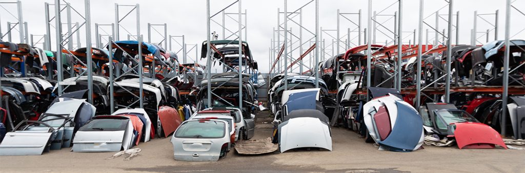 sorted Racks of dismantle auto parts for scrap and metal salvage