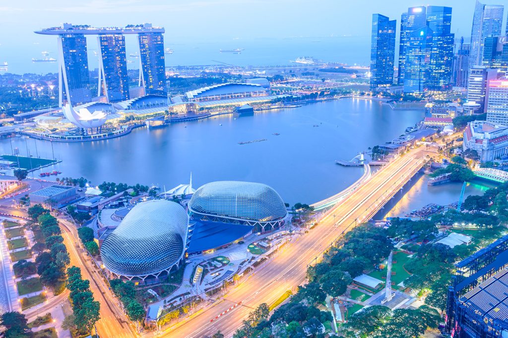 bird's eye view of the Marina Bay with Singapore cars driving down Esplanade Bridge